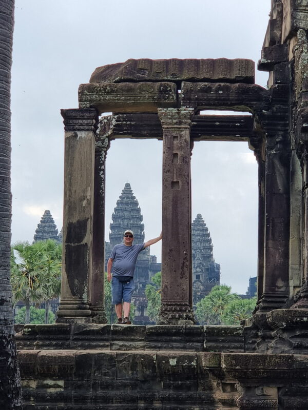 Author standing amongst the ruins of Angkor Wat in Cambodia