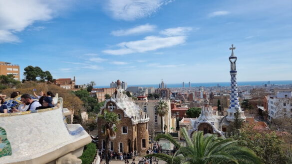 View over Barcelona from Park Güell, with Gaudí architecture in the foreground and the Mediterranean in the distance