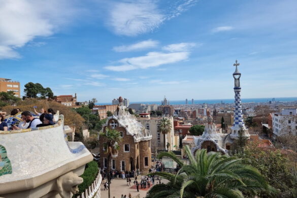 View over Barcelona from Park Güell, with Gaudí architecture in the foreground and the Mediterranean in the distance