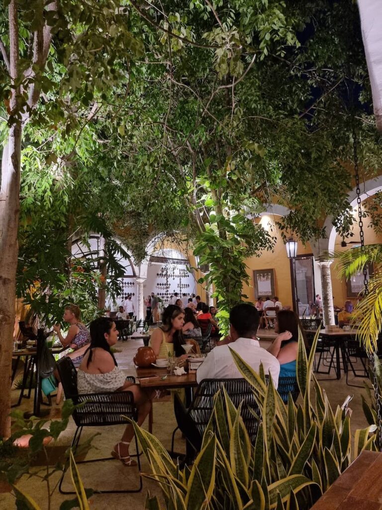 People eating a meal in the evening outdoors in Parque Santa Lucia in Mérida Mexico